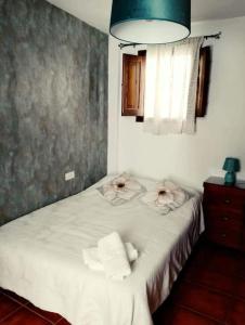 1 dormitorio con 1 cama con toallas en Claustro Home Casco Histórico Córdoba, en Córdoba