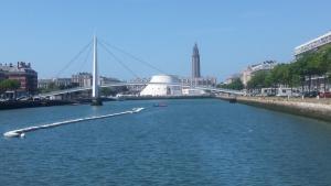 un puente sobre un río con un barco en el agua en MAIRIE, Apart 50 m2 , Lumineux , Rénové , 4 Pers., en Le Havre