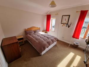 a bedroom with a bed and red curtains at Entire house with parking, centrally located & close to Aviva Stadium in Dublin