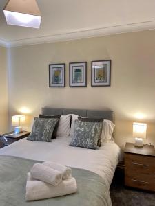 a bedroom with a bed with two towels on it at Maidstone-Penenden House in Maidstone