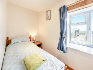 a bedroom with a bed and a window at The Granary in Arlington