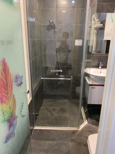 a shower in a bathroom with a person taking a picture at Crescent Bay SUP in Shuili