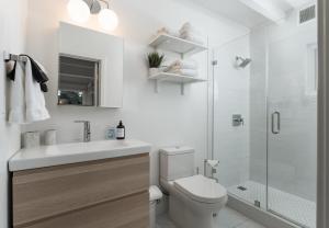 a bathroom with a sink and a toilet and a shower at Palm Cottage in Montecito +14 photos