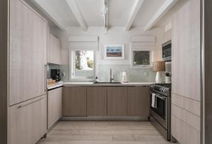a kitchen with wooden cabinets and a sink at Palm Cottage in Montecito