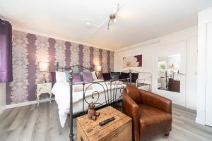 a bedroom with a bed and a chair at 11 Boutique studio apartment perfect for peaceful getaway, secluded garden, quiet location in High Wycombe +9 photos