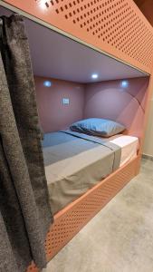 A bed or beds in a room at Bedcoin Hostel