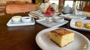 a piece of cake on a white plate on a table at CHALÉ CAPOEIRA DOS MILAGRES in São Miguel dos Milagres
