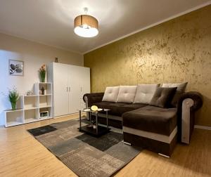 a living room with a couch and a table at New Studio Apartment Timisoara Town in Timişoara