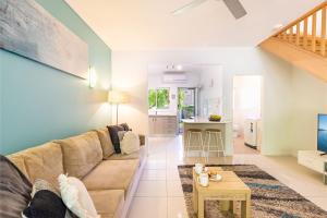 a living room with a couch and a table at Florida 1 2 min walk to beach shops and restaurants in Shoal Bay