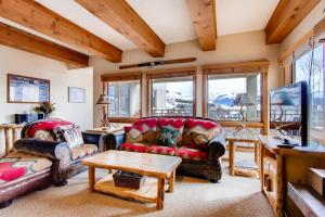 a living room with two couches and a table at Rustic 3 Br Condominium Condo in Crested Butte