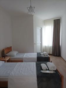 a hotel room with two beds with towels on them at Orenda in Tʼelavi