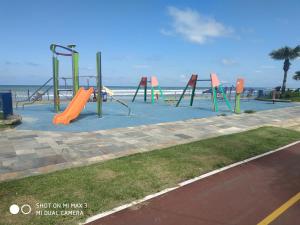 a playground on the beach with an orange slide at Pousada Praia Grande Solemar in Praia Grande
