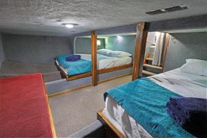 a small room with two beds and a mirror at Caloundra Houseboats in Pelican Waters