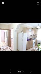 a kitchen with a white refrigerator in a room at Galata Apart Suite in Bostancı