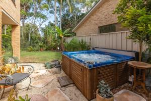 a hot tub in the backyard of a house at 21 Cedar Grove in Forster