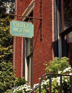 a sign for a guild house on a brick building at Guild House Hotel in Philadelphia