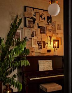 a room with a piano and a wall of papers at Guild House Hotel in Philadelphia