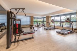 a gym with a bunch of treadmills and machines at Guangzhou Baiyun Airport MeHood Liz Hotel Free Canton Fair Shuttle Bus &Official Registration Agency in Guangzhou