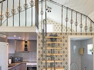 a kitchen with a spiral staircase in a house at Holiday home HUDDINGE II in Huddinge