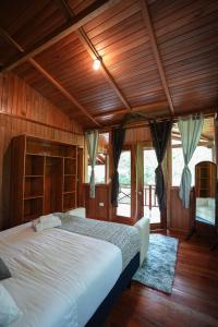 A bed or beds in a room at The Wooden House Mindo