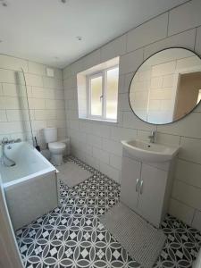 a bathroom with a sink and a toilet and a mirror at 17A Stella house nr Bath in Radstock