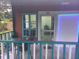 a balcony with a table and chairs and a door at CABAÑA 6 in Pereira