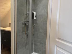 a shower with a glass door in a bathroom at Gîte en pleine nature avec vue, climatisation et terrasse - FR-1-489-441 in Saint-Léon +5 photos