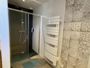 a bathroom with a shower and a glass shower stall at Gîte Saint-Léon, 3 pièces, 5 personnes - FR-1-489-440 