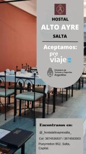 a sign for a restaurant with tables and chairs at Hostal Alto Ayre Salta in Salta