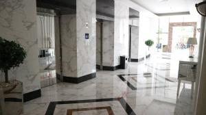 a lobby with white marble walls and a glass floor at Apartemen Tera Residence in Bandung +31 photos