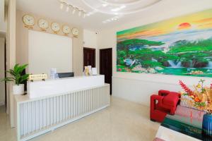 a waiting room with a counter and a large painting at TTR Vincent Hotel in Da Lat