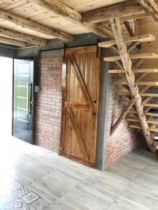 a wooden door in a room with a brick wall at Finca Las Liebres in San Rafael