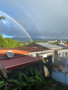 Un arc-en-ciel au-dessus de certains bâtiments dans l'établissement La Porte Du Paradis, à Fort-de-France