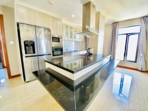 a kitchen with a glass counter top in a room at Malis the Residence in Phnom Penh