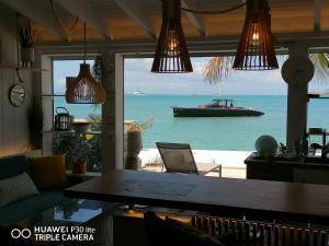 a boat in the water in a room with a table at Love Beach Loft in Marigot