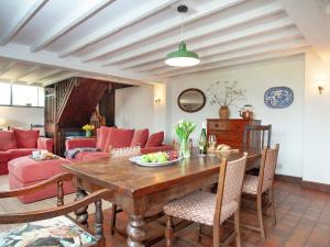 a living room with a wooden table and chairs at Chapel Cottage in Lydford
