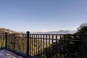 a balcony with a view of the mountains at EllBee Mussoorie Hills in Mussoorie