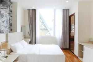 Postel nebo postele na pokoji v ubytování TTR Vincent Hotel