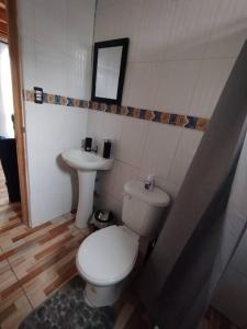a bathroom with a toilet and a sink at casa en la playa in Buchupureo