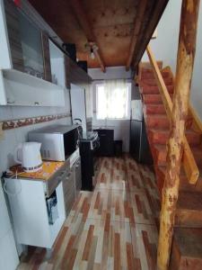 a small kitchen with a staircase in a house at casa en la playa in Buchupureo