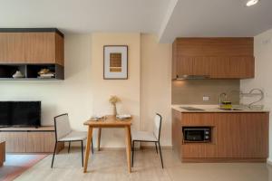 a kitchen and dining room with a table and chairs at Lacasita Near Beach Huahin (Room652) in Hua Hin