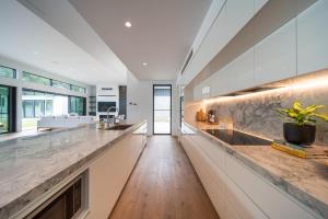 a kitchen with marble countertops and a long counter top at Launa Killcare Heights in Killcare