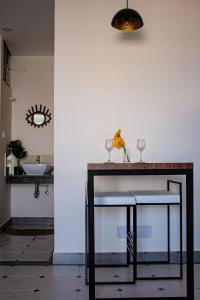 a table in a room with a sink and a mirror at Casa Mel in Puducherry