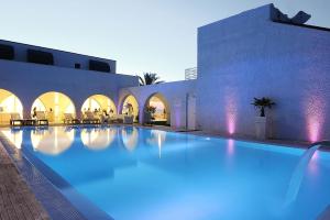 a swimming pool with blue lights in a building at Hotel Sporting in Casalbordino