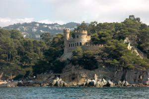 a castle on an island in the water at Hotel Xaine Park in Lloret de Mar
