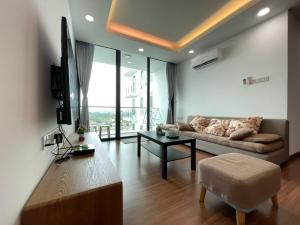 a living room with a couch and a table at A.Foo Homestay 4.0 @ Vivacity Megamall Jazz Suite 4 in Kuching