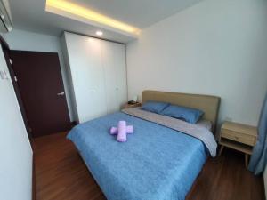 a pink toy sitting on a bed in a bedroom at A.Foo Homestay 4.0 @ Vivacity Megamall Jazz Suite 4 in Kuching