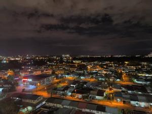 a city lit up at night with lights at A.Foo Homestay 4.0 @ Vivacity Megamall Jazz Suite 4 in Kuching