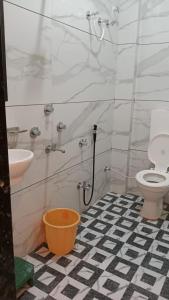 Hotel shivalay palace في Maheshwar: حمام به مرحاض أبيض ومغسلة