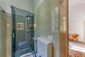 a bathroom with a toilet and a glass shower at Luisa in Leuca +30 photos